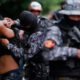 Photo of police frisking a man in El Salvador