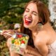 Photo of a woman eating a salad