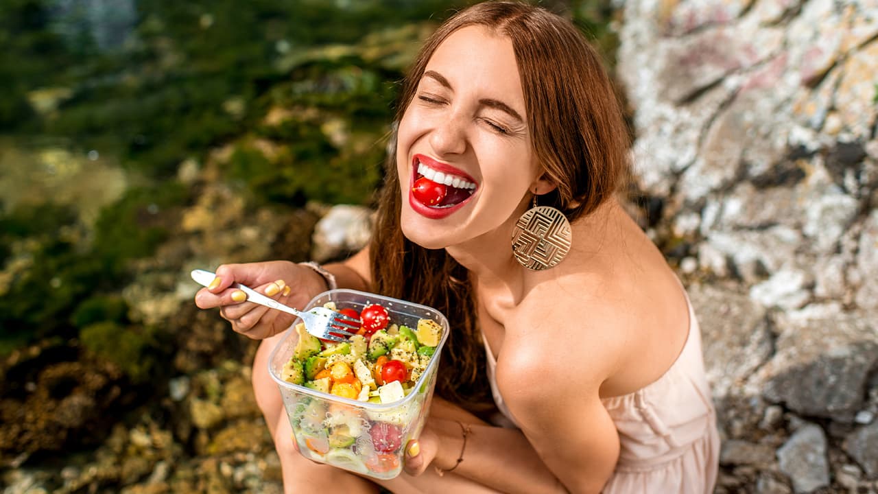 Photo of a woman eating a salad