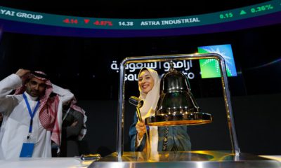 Photo of Sukaynah Al Oqaili ringing the stock bell