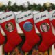 composite image of Christmas stockings and portraits of politicians