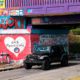 Photo of a vehicle driving by a tribute to the victims of the Naval Air Station Pensacola