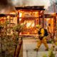 Photo of Woodbridge firefighter Joe Zurilgen passing a burning home