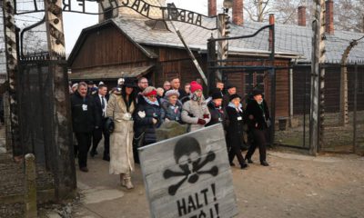 Poland's President Andrzej Duda walking along with survivors through the gates of the Auschwitz Nazi concentration camp to attend the 75th anniversary of its liberation