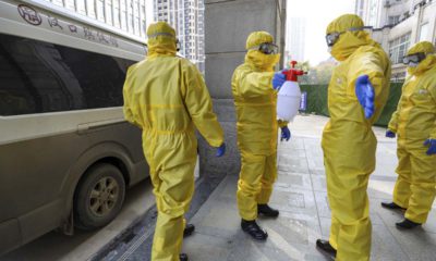 Photo of funeral workers disinfecting themselves