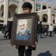 Photo of a boy holding a portrait of Iranian Revolutionary Guard Gen. Qassem Soleimani, who was killed in the U.S. airstrike in Iraq