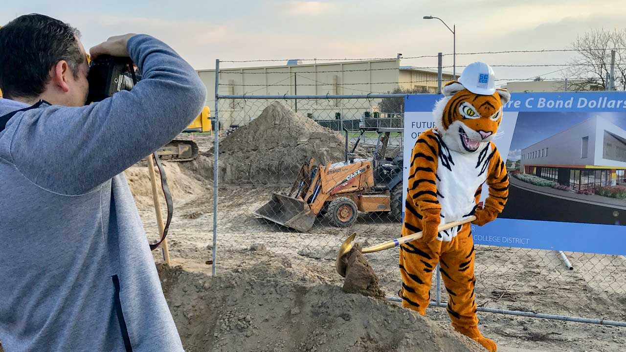 Photo of the Reedley College mascot shoveling dirt during a groundbreaking event