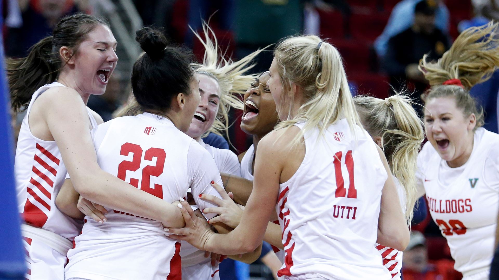 Photo of Fresno State women's basketball team celebrating a victoryta