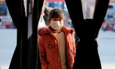 Photo of a girl standing outside of a shop in Wuhan