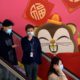 Photo of people wearing face masks as they ride an escalator in China