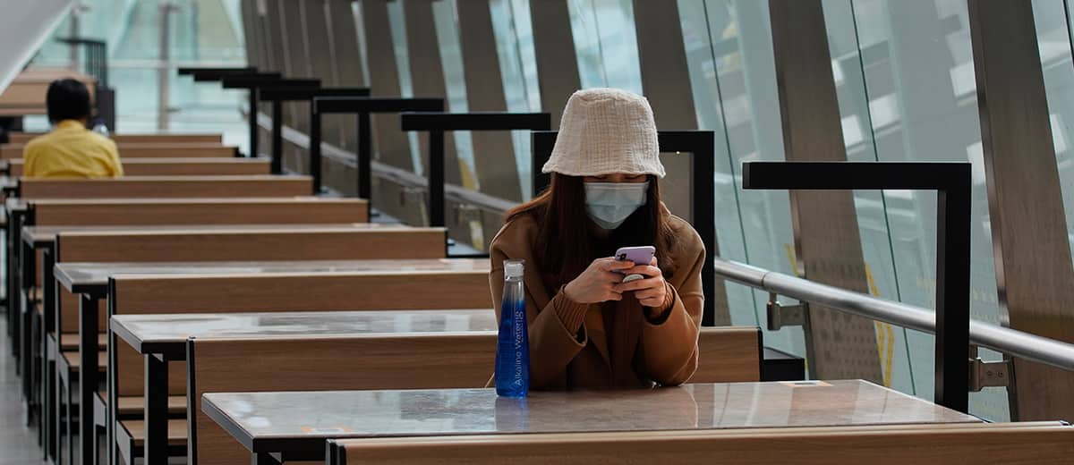 Photo of a woman wearing a protective face mask at the high speed train station in Hong Kong