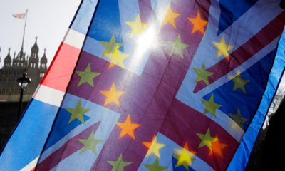 Photo of European Union and Union flags outside Parliament in London