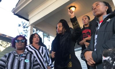 Photo of women standing outside a vacant house in Oakland, Ca.