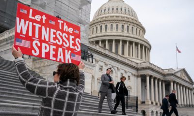 Photo of A woman holding a sign for members of the House