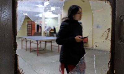 Photo of a student seen through broken glass