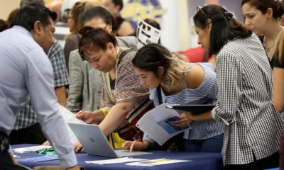 Photo of applicants looking at available jobs