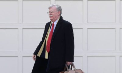 Photo of John Bolton leaving his house