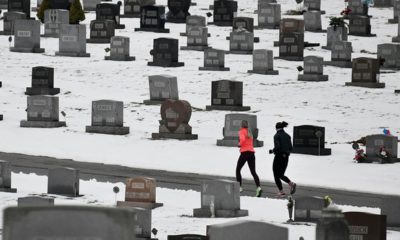 Photo of joggers running through a cemetery