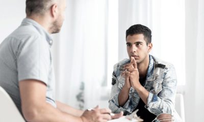 Photo of a psychologist counseling a male teenager