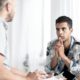 Photo of a psychologist counseling a male teenager