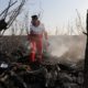 Photo of a rescue worker searching the scene where a Ukrainian plan crashed