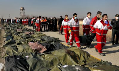 Photo of rescue workers carrying the body of a victim of a Ukrainian plane crash in Shahedshahr