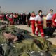 Photo of rescue workers carrying the body of a victim of a Ukrainian plane crash in Shahedshahr