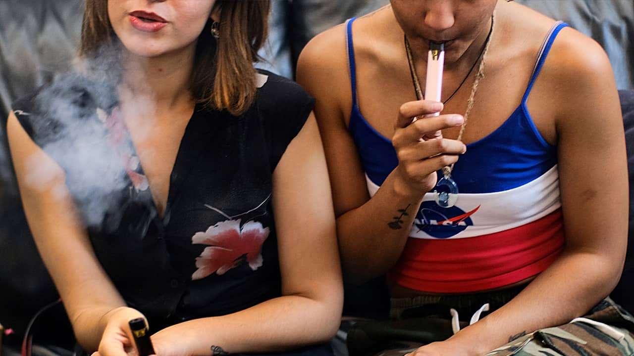 Photo of two women vaping at a party in Los Angeles