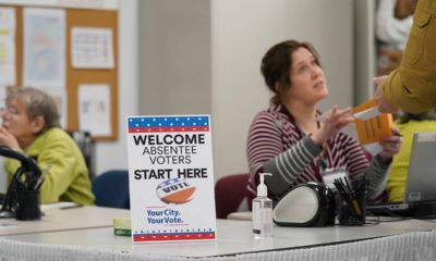 Photo of a poll worker speaking to a voter