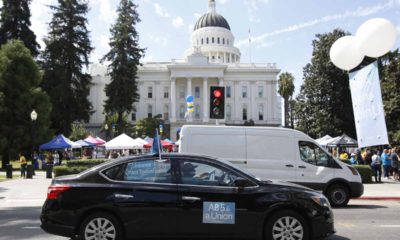 Photo of a car with banners supporting AB 5, the California law reclassifying independent contractors