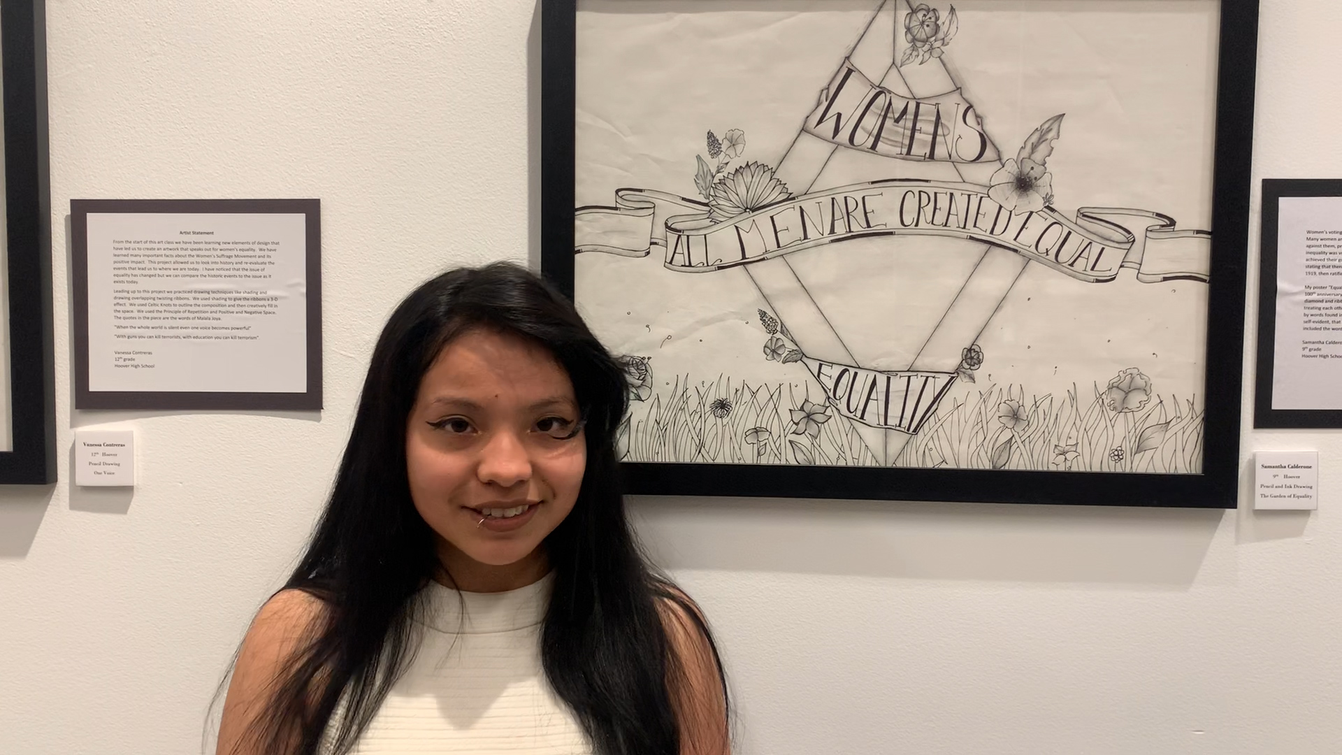 Photo of a Hoover High student in front of her artwork at M Street Street Arts Complex