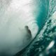 Surfer in the barrel of a wave .