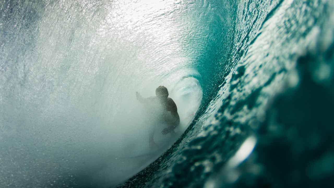 Surfer in the barrel of a wave .