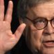 Photo of Attorney General William Barr putting his hand up