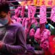 Photo of a man wearing a face mask in front of a meat booth in Hong Kong