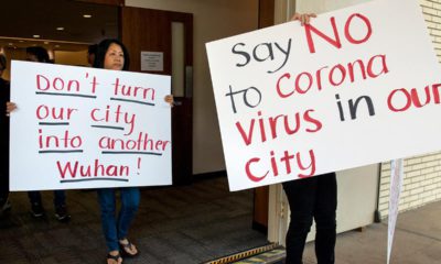 Photo of protesters holding signs in Costa Mesa, Calif.