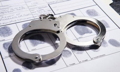 Photo of handcuffs on top of a fingerprint record
