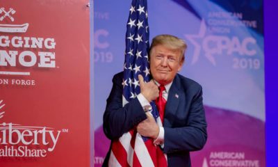 Photo of President Donald Trump hugging the American flag