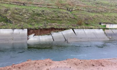 Photo of a canal with a damaged wall