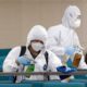 Photo of workers disinfecting a gym in South Korea