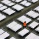 Photo of workers arranging beds in a convention center