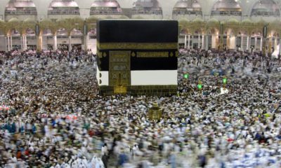 Photo of Muslim pilgrams walking around the Kabaa