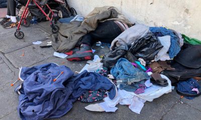 Photo of sleeping people and used needles on the ground in San Francisco