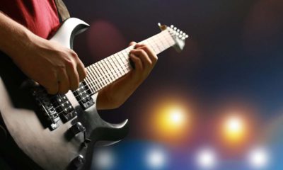 Photo of a man playing a guitar