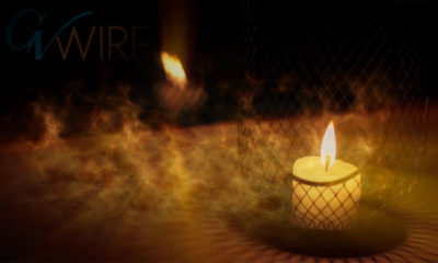 photo of a candle burning at night outside