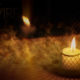 photo of a candle burning at night outside