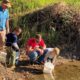 Photo of volunteers releasing trout fry into the Kings River