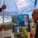 Photo of Israeli Arabs in a coffee shop near an election campaign poster showing Israeli Politician Ahmad Tibi of the Joint List in Tira, Israel