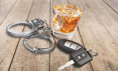 Photo of alcohol, keys and handcuffs symbolizing a drunk driving arrest
