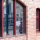 Photo of a man looking out the window of a restaurant